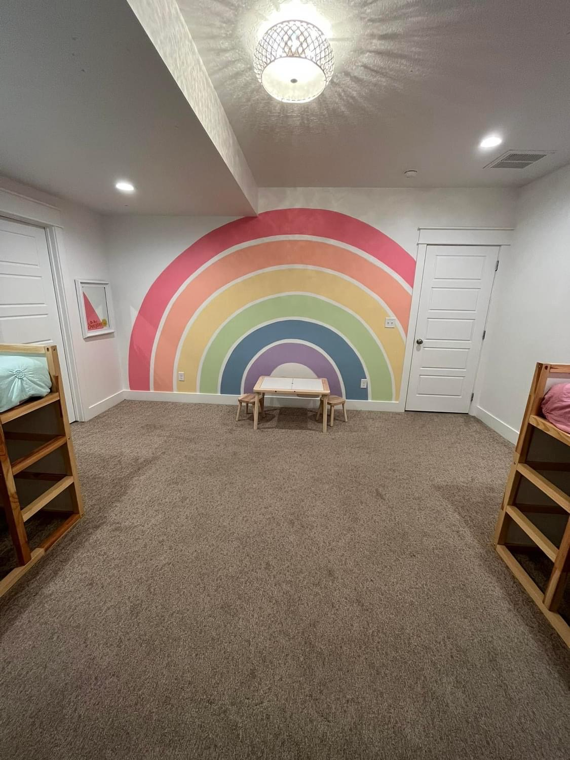 Picture of the basement bedroom 5 showing rainbow artwork on the wall.