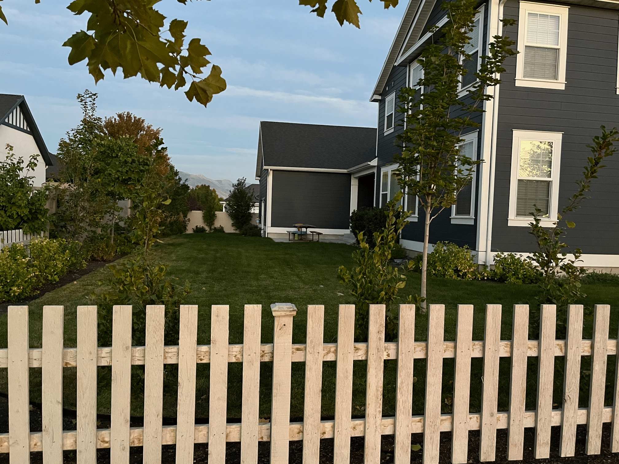 Picture of backyard over picket fence